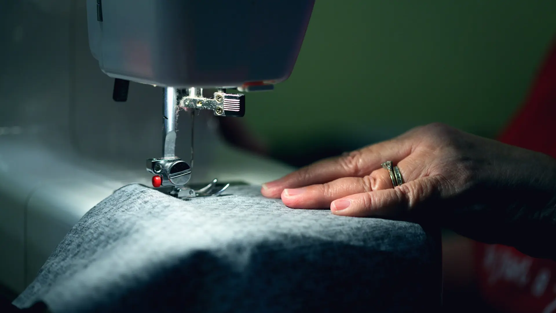 person in gray shirt sewing