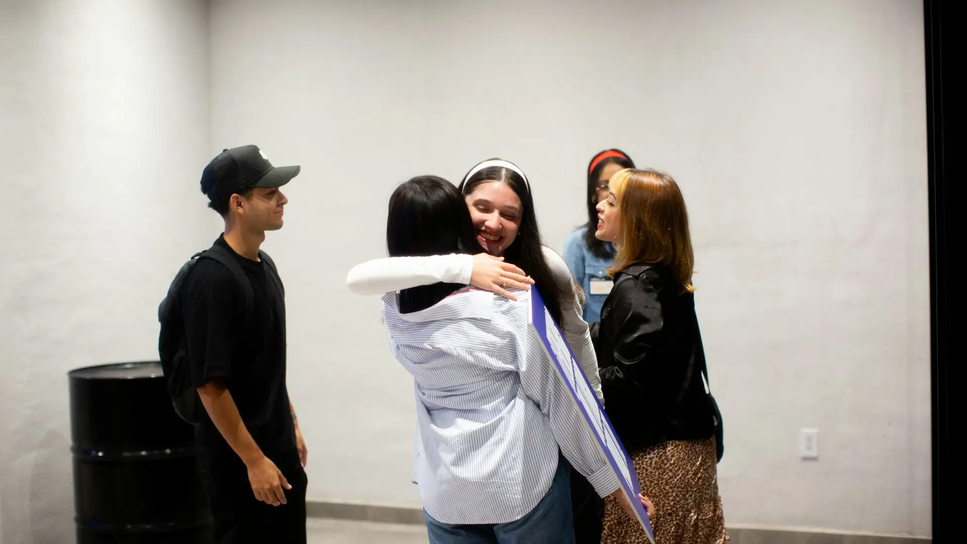 A group of people standing around each other